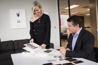 Kriste Michelini, founder of Kriste Michelini Interiors, and Sean Callahan, CEO of YDesign, consult on upholstery options.