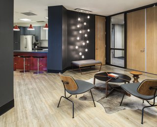 The front entry and waiting area is stylish and sleek with a blend of Blu Dot and Herman Miller furnishings atop a hide rug from Forsyth.