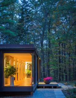 A steady rhythm of interior columns supports the simple framework. Architect Ron Rea created a lighting solution on the columns which appears as though it was always there.