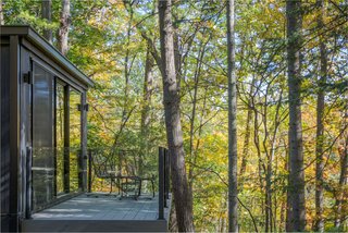 Off the master bedroom, a private deck looks out to the forest.