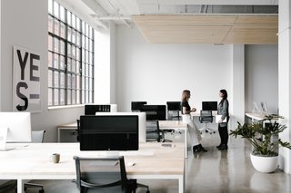 The office spaces are set up for flexibility. Custom-made desks include hidden troughs for wire management and accessibility.