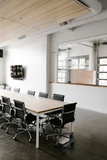 The lower level also holds meeting rooms. Glazed openings allow the open concept to extend onto the lower level.