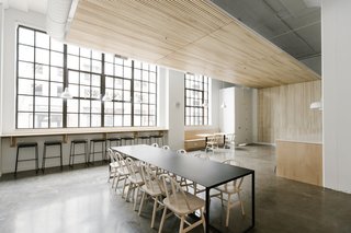 The wood slats suspended from the ceiling draw warmth into the room while improving acoustics in the open space.