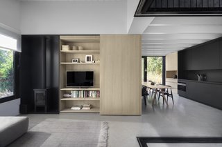Beautifully detailed built-ins store home necessities. A wood-burning fireplace adds a rustic feel to this modern cabin.