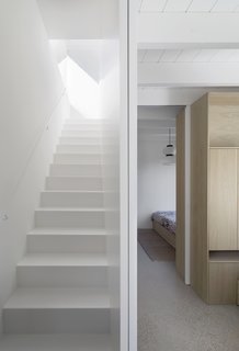 White walls and ceilings allow daylight to bounce and filter through the interior spaces. 