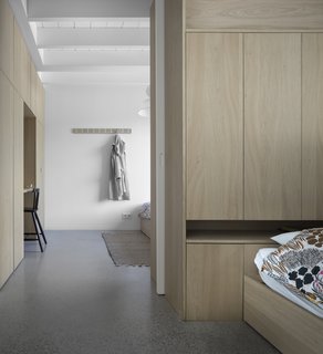 Oak built-ins provide functional storage and separation between the adjoined bedrooms on the main floor. A large pocket door combines or separates the two sleeping quarters.