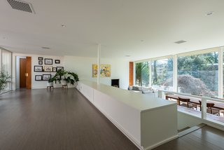 The open, split-level plan allows for continuous flow from space to space, and uninterrupted views from the inside out. The original radiant heating system remains, and cool gray cork floors provide comfort and warmth.