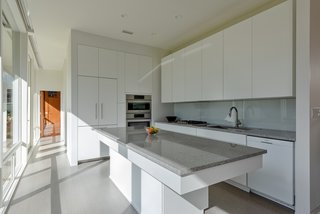 Sleek, white custom cabinets quietly tie in with the original character of the home.