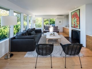 Walnut casework anchors both sides of the original fireplace. Steel plate provides a modern interpretation of the traditional hearth.