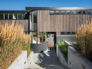 A refined, simple exterior palette of wood, stucco, and concrete allows the true architectural form to shine and blend in with the landscape.
