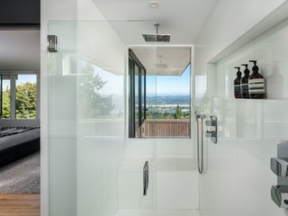 Even in the master bathroom, the views do not go unnoticed. A picture window perfectly frames Mount Hood in the distance.