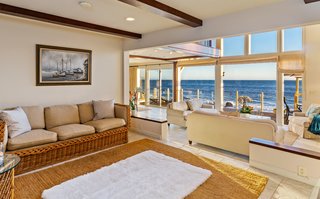 An open floor plan provides continuous living spaces with uninterrupted ocean views. 