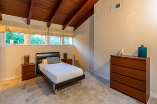The wood-beamed ceilings carry into the additional en-suite bedrooms which feature beach or mountain views. 