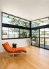 Modern home with Living Room, Chair, Recliner, End Tables, Table, Stools, Ceiling Lighting, Recessed Lighting, and Light Hardwood Floor. Lounge with Milo Baughman "Modern Wave" chaise lounge at top of stairs Photo 13 of Ridgemont Residence