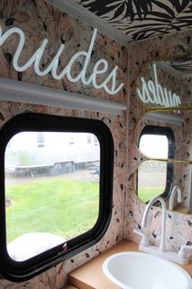 A Portland Couple Renovate a 1982 RV, Turning It Into Their New Home - Photo 10 of 12 - Kamarul gave the bathroom a playful upgrade with pink flamingo wallpaper and a neon sign.