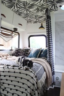 A Portland Couple Renovate a 1982 RV, Turning It Into Their New Home - Photo 12 of 12 - One of their dogs, Cudi, blends in with textiles that overflow on the bed in their RV.