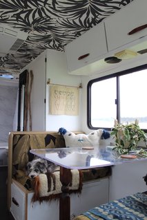 A Portland Couple Renovate a 1982 RV, Turning It Into Their New Home - Photo 7 of 12 - Kamarul used an acrylic tabletop for the dinette to open up the space visually.