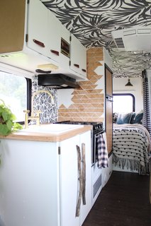 A Portland Couple Renovate a 1982 RV, Turning It Into Their New Home - Photo 9 of 12 - Kamarul added depth to one side of the kitchen by cascading triangles made out of plywood down the wall.