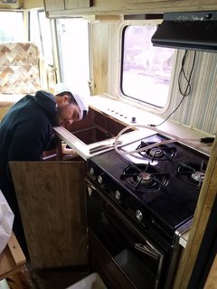 A Portland Couple Renovate a 1982 RV, Turning It Into Their New Home - Photo 5 of 12 - Tim Kamarul working on the RV's plumbing.