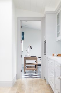 What's the Most Overlooked Feature When Planning a Kitchen Renovation? - Photo 16 of 17 - A light, reclaimed wood floor transitions to a glossy, patterned marble surface as the home transitions from the kitchen to the office.