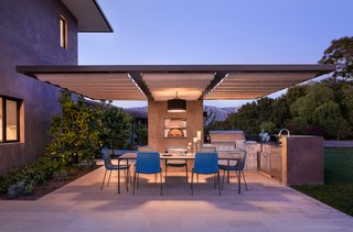 "Designed to take advantage of expansive ocean, island, and mountain views, this contemporary remodel and addition recycled the original 1948 ranch house to create a new two-story home with an open plan layout," says Blackbird Architects. The outdoor hardscape and garden include a reflection koi pond and palm island at the entry, green roofs, an outdoor kitchen, a pizza oven, and a fire pit.