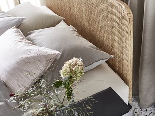 The Delaktig bed frame with a rattan headboard costs $479.