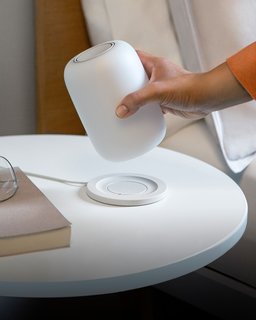 A wireless charging pad keeps the lamp's battery topped up all night long.