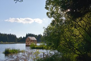 A New Book For Those Who Dream of Living in a Floating Home - Photo 3 of 11 - Built in the same dimensions as poet Henry David Thoreau’s Walden Pond cabin, this small 13-by-8-foot dwelling is an art installation on France's Lac de Gayme and was constructed out of reclaimed wood and recyclable acrylic glass. 