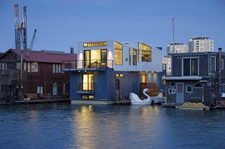 A New Book For Those Who Dream of Living in a Floating Home - Photo 5 of 11 - Paying homage to San Francisco’s industrial history, this floating home by Robert Nebolon incorporates metal siding, a sawtooth roof, and warehouse-style window casements on the exterior. Inside, the three-level, 2,100-square-foot home has an open and flowing floor plan on the top floor, where the living areas are located. The middle and lower floors hold the bedrooms, bathrooms, and storage areas. 