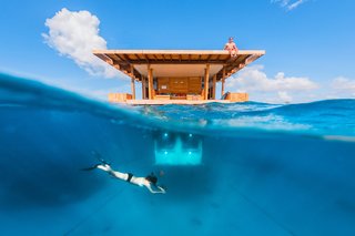 A New Book For Those Who Dream of Living in a Floating Home - Photo 11 of 11 - Off the coast of Tanzania in the Indian Ocean, Manta Resort’s "Underwater Room" is a three-level suite surrounded by a coral reef. Below water, guests can watch marine life—while on the rooftop deck, they can soak up the sun. 