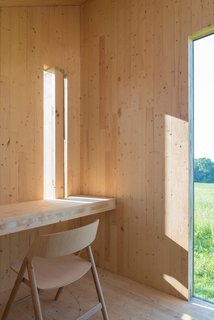 With an interior clad in wood and outfitted with a CLT bench and desk that laterally brace the small structure, this mobile writing shed is simple but effective. We love the idea of using a few pieces of carefully chosen furniture, especially for a she shed, where space is precious, but the use of the space might be a bit more focused.