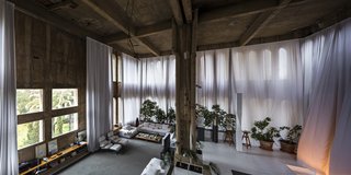 The voluminous living room has plenty of windows, letting in an abundance of natural light.