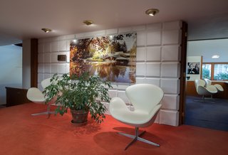 A Midcentury Time Capsule Captures an Architect's Love For Iconic Design - Photo 2 of 14 - Danish architect and designer Arne Jacobsen's Swan Chairs, which originally were designed for the SAS Royal Hotel in Copenhagen, showcase the progressive sculptural forms and synthetic materials of the 1950s.