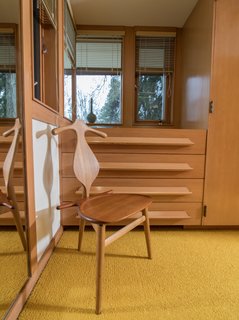 A Midcentury Time Capsule Captures an Architect's Love For Iconic Design - Photo 3 of 14 - Produced by world-renowned Danish furniture maker Johannes Hansen in the late 1950s, Hans Wegner’s sculptural Valet Chair’s compact size made it popular for post-war families who lived in smaller spaces. And, its quality and inexpensive price tag allowed middle-class families to furnish their homes with the chair. 