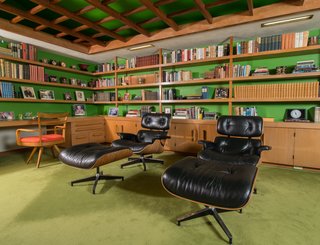 A Midcentury Time Capsule Captures an Architect's Love For Iconic Design - Photo 5 of 14 - The rosewood-veneered molded plywood and leather swivel Eames Lounge Chair and Ottoman, which was designed for the furniture company Herman Miller, was intended to have a "warm receptive look of a well-used first baseman’s mitt," which was achieved by buttoning the leather to create creasing in the black hide.