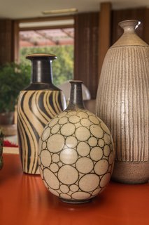 A Midcentury Time Capsule Captures an Architect's Love For Iconic Design - Photo 12 of 14 - Two vases by Harrison McIntosh are displayed in the living room.