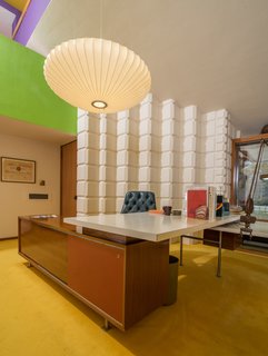 A Midcentury Time Capsule Captures an Architect's Love For Iconic Design - Photo 14 of 14 - Dow also incorporated iconic pieces of furniture and decorative objects into his office, like George Nelson's Saucer Lamp, which hangs above his desk.
