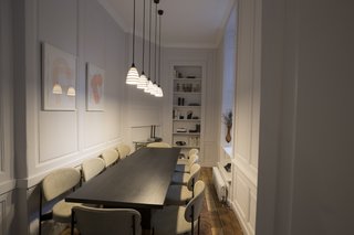 A conference room with comfortable contemporary furnishings provides space for large meetings.