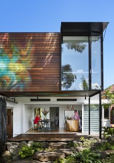 Sliding glass panels allow the kitchen and dining area to seamlessly flow into the Japanese-inspired garden.