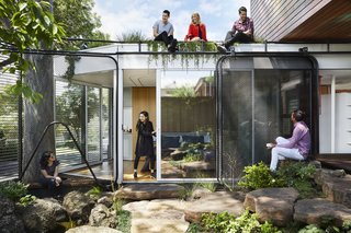 The roof garden, lush with edible plantings, is accessible by ladder. 