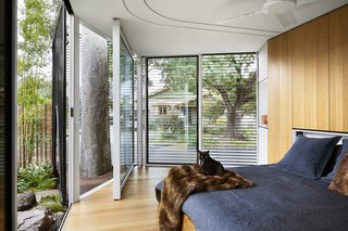 Although the master suite overlooks the back street, shutters offer privacy.