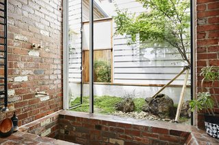 The shower area and sunken brick tub were constructed using red clay bricks salvaged from demolition sites around Victoria. 