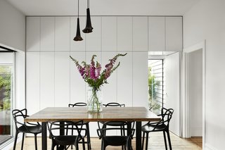 Floor-to-ceiling white cabinetry maximizes kitchen storage.