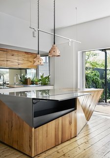The stainless-steel and timber island maximizes space with a secret hatch that opens to add extra surface area for food prep. 