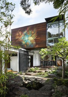Damon Fuhrer Landscapes created a Japanese-inspired garden that incorporated bamboo, moss-covered boulders, and a water feature. 