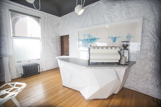 The shared spaces include lounges, co-working areas, and a coffee bar.