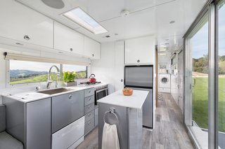 Taking design cues from boats, the Hofmanns used maintenance-free, weather-resistant aluminum for the interior walls and midcentury-style cabinetry. High-end appliances like a dishwasher and washer-drier combo are small and tucked away.
