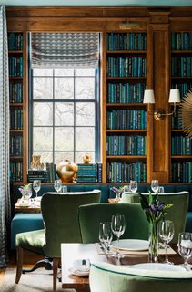 In the Library, built-in bookcases and a long banquette (upholstered in Kravet’s Versailles Velvet fabric, color E25600) were installed on the far side of the room. 