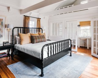 Inside the cottage are two bedrooms that have been updated with crisp white paint, new linens, and light fixtures.