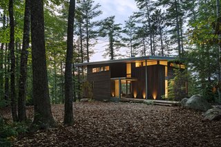 Cedar siding is stained in dark brown to camouflage the cabin with the surrounding forest. "It was important that this house appears modern and blends in," says Murdough. 